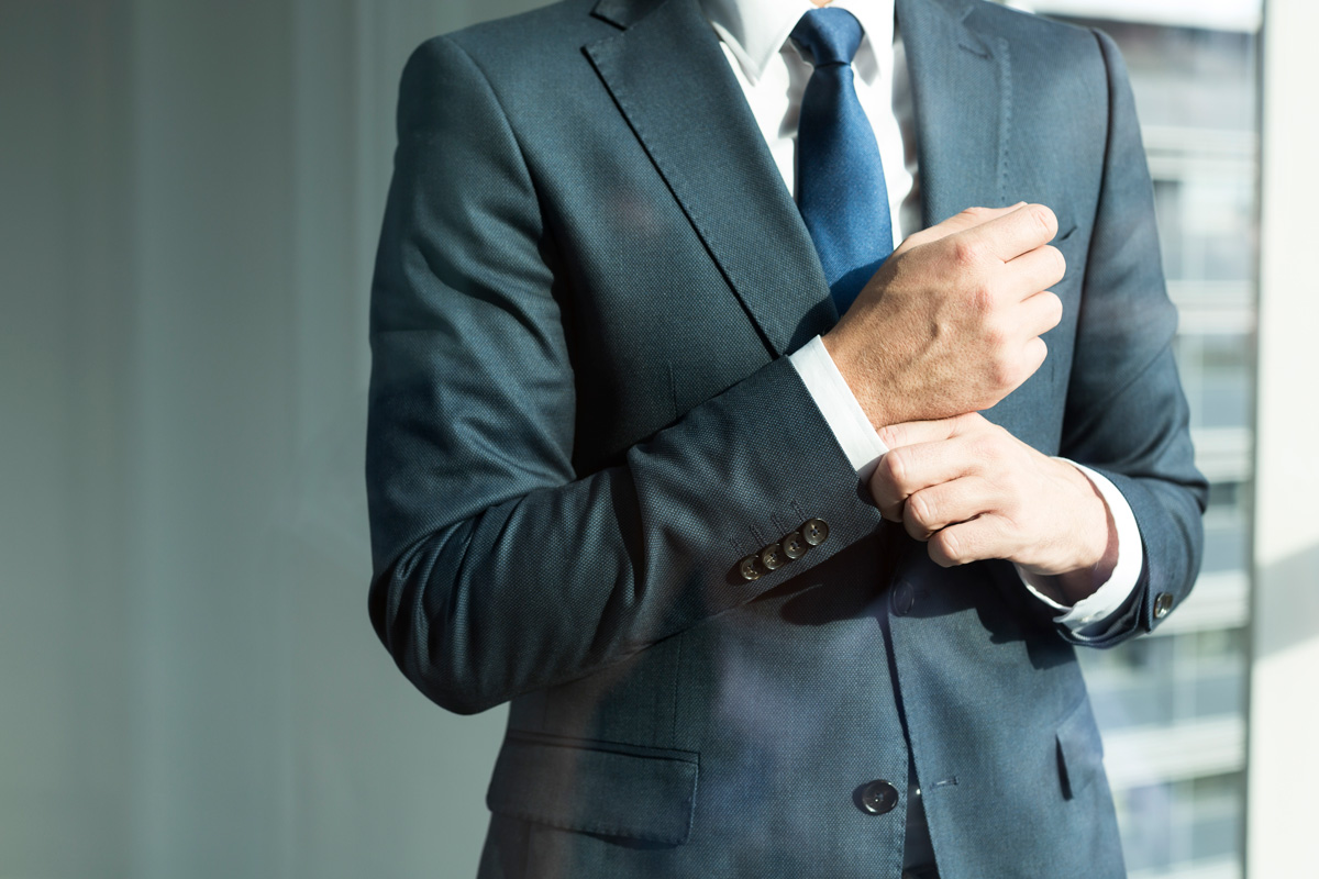 well-dressed-man-adjusting-cuff-in-modern-office-2026-01-05-00-45-47-utc